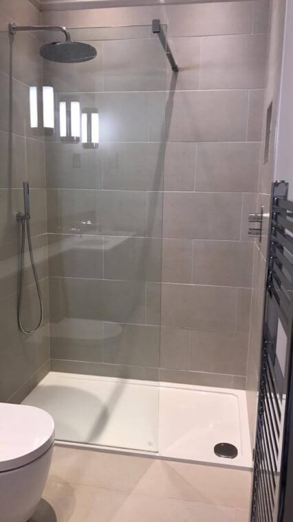 modern walk in shower with waterfall shower head