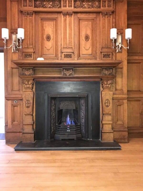 Grand Fireplace grand fireplace with wood surround and sconces